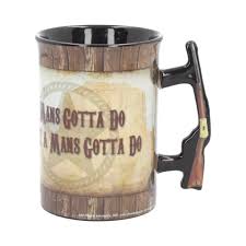 A quote reading, courage is being scared. Mug John Wayne A Mans Gotta Do 16oz