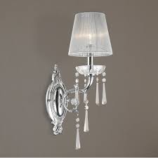 This stylish sconce features a combination finish of artisan bronze and an old satin brass socket cover with a clear glass shade. W23131c6 Orleans 1 Light Arm Chrome Finish And Clear Crystal Wall Sconce Light With White String Shade