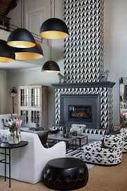 Interior design scene of brown wall with couch and tribal masks copy space on top. 5 African Luxury Interior Designers You Should Know Onchek