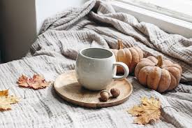Premium Photo | Cozy autumn morning breakfast still life scene cup of hot  coffee tea standing on wooden plate near window fall thanksgiving concept  orange pumpkins acorns and maple leaves on cotton