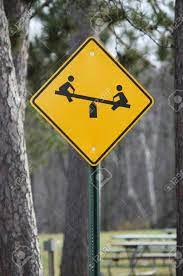 Retired playground ahead sign see saw 36 x 36 reflective dot real street sign. Photograph Of A Children At Play Sign With A Teeter Totter On Stock Photo Picture And Royalty Free Image Image 8158685