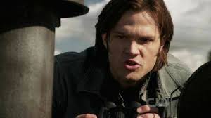 Which Supernatural episode features Sam and Dean getting weapons from the  trunk with Dean twirling a sawed-off shotgun?