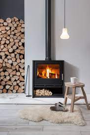 Iron fireplace like a stove in a house with fire, scandinavian interior modern design, white room. My Scandinavian Home Feeling The Hygge A Toasty Guide To Wood Burning Stoves