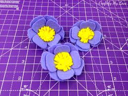 After a few turns, secure the center of the flower with a paper clip or bobby pin. Diy Felt Flower Anemone 1 Of 5 Craftify My Love