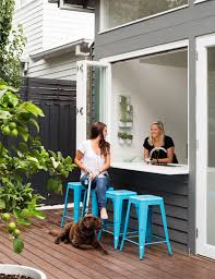 Beach cottage kitchen with a pass through window, zinc countertops and brown leather swivel barstools. 10 Cozy Super Cute Kitchen Window Bar Designs My Cosy Retreat