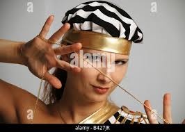 Close up image of young stripy orange and yellow pet corn snake. Catch  light in black beady eye and frame filling body curves Stock Photo