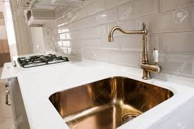 This silver spring, md., kitchen by zoe feldman design uses polished nickel plumbing fixtures, satin brass. Angle View Of Kitchen Sink With Gold Faucet Stock Photo Picture And Royalty Free Image Image 72563753