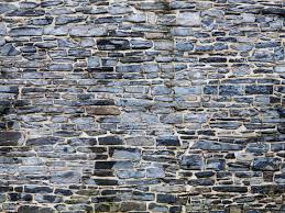 I've got a bunch of rough stone that i dug up in my garden, and i'd like to build a wall as a landscaping feature. How To Build Mortared Stone Walls