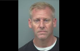 Police: DeKalb cop held gun to neighbor's head, threatened to kill him