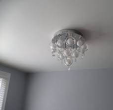 Grey Lounge With Modern Glass Chandelier Bottlefly Wings Paint By Valspar Interior Paint Modern Glass Chandeliers Lowes Interior Paint