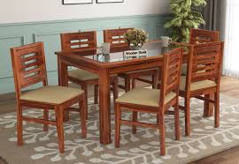 For a sleek, modern appearance, try a glass top dining room set with a clear pane resting on a metal base. Buy Janet 6 Seater Dining Set With Glass Top Honey Finish Online In India Wooden Street