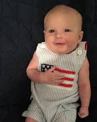 Baby in Patriotic Onesie With Hand