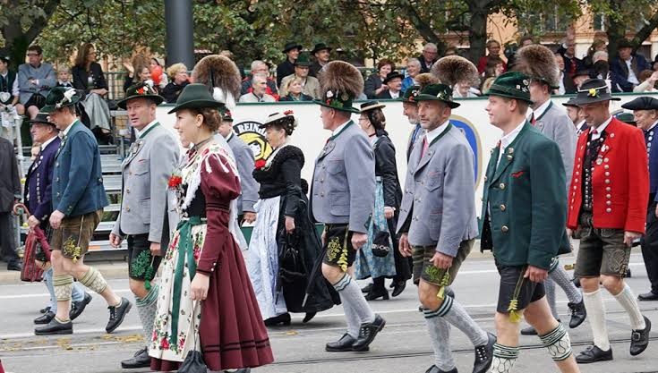 Crowds in traditional Bavarian clothing gathering at Oktoberfest in Munich.