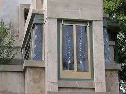 Close window outside corner with green glass with a curtain inside and cloudy sky in the background. Datei Hollyhock House Corner Window Jpg Wikipedia