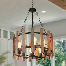 Wrought iron and heavy wood are the most common materials used a glass table and metal chairs are surrounded by abundant garden landscaping in this outdoor patio dining area. Wood Metal Chandelier Orb Rustic Industrial Hanging Light Fixture 8 Lights Ebay