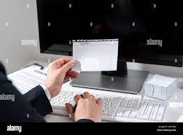 Businesswoman Holding Pen And Important Message Wtitten On Paper On Desk  With Computer, Clipboard And Notes. Crutial News Presented On Notepad On  Table With Keyboard And Pc Stock Photo - Alamy