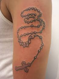 The praying hands with rosary beads are carved in the background of the cross in black and gray style. Rosary Tattoos Designs Ideas And Meaning Tattoos For You