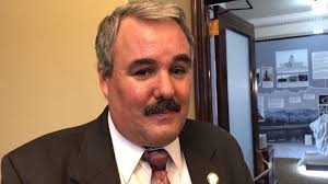 Student who is blind helps lawmaker learn to use a white cane and  experience low vision.