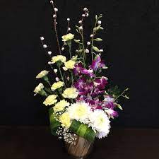 Purple Orchids Carnations And Chrysanthemums Flower Arrangement In Brass Coloured Ba Chrysanthemum Flower Arrangement Chrysanthemum Flower Flower Arrangements