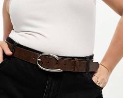 Image of woman wearing a belt with an oversized buckle
