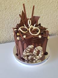 Chocolate Drip Cake Loaded With Tempered Chocolate Decorations For A 60th Birthday Cake Drip Cakes Chocolate Drip Cake