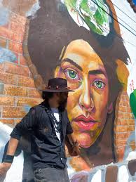 Resident artist touches up the facade