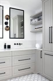 Grey stained wood cabinets look super modern and the black and wood shelving along with the wood panelled ceiling lend this kitchen an industrial feel. Gray Cabinets With Marble Counter And Black Hardware And Wall Mounted Faucet In Bathroom Bathroom Style Kitchen Cupboard Handles Contemporary Bathroom