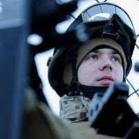 US Army Captain P. Lain Hancock, Commander of C Company, 1ST Battalion,  227th Aviation Regiment, 1ST Cavalry Division, Texas, looks down from the  cockpit of his AH-64D Apache Longbow Helicopter. CPT Hancock