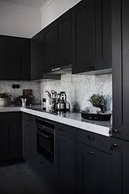 Two black iron pendant lights contribute to the traditional, country charm vibe. 25 Ultimate Black Kitchen Designs That Wow Shelterness