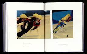 ONE BY ONE, THE SKATERS GLIDE INTO THEIR STARTING POSITIONS, SHAKING THE  LAST JITTERS FROM THEIR POWERFUL LEGS AS THE ANNOUNCER