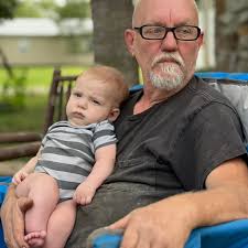 How to reduce the risk of a tractor tipping when moving heavy logs?