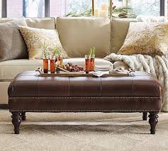 10 coffee table ottomans for an inviting living room. Martin Tufted Leather Ottoman Pottery Barn