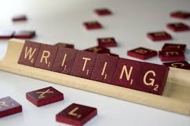 The word "writing"with scrabble tiles