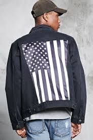 a distressed denim jacket featuring a back satin patch with