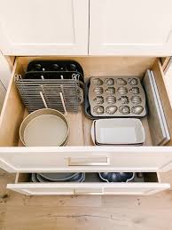 Open frame kitchen cabinets can look more modern or more traditional, depending on the design of the kitchen and extra deep drawers can store dishware, dreaded tupperware, and even crockpots! How To Organize Kitchen Drawers Modern Glam Interiors