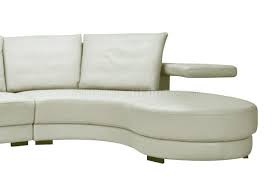 Clean lines and sleek surfaces abound in this modern living room, bathed in sunlight through full height windows. Oversized Sectional Sofa In Off White Leather