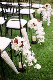 Garden Wedding Aisle Lined With White And Red Floral Arrangements And White Paper Umbrellas Wedding Aisle Decorations Wedding Aisle Cheap Wedding Centerpieces