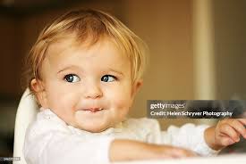 Blonde baby girl (Cute Baby Girl With Blonde Hair In The Blooming Garden  Stock Photo)
