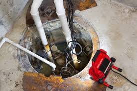 A sump pump is installed in a sump pit, which is usually in an out of the way place in a basement, like the mechanical room. Repairing A Sump Pump In A Basement With A Red Led Light Illuminating Stock Photo Picture And Royalty Free Image Image 24628366