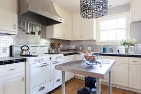 Dark birch kitchen cabinets with shining white quartz counters and white marble backsplash. 15 Stunning Kitchen Backsplashes Diy Network Blog Made Remade Diy