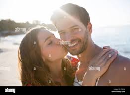 Happy woman being kissed man hi-res stock photography and images - Alamy
