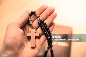 Black Rosary Cross In Hand Stock Photo
