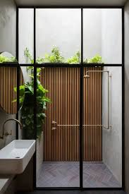 This glorious outdoor bathroom design uses wooden wall divider for privacy between the door and the shower, and also to hang up towels for easy access. Indoor Outdoor Bathrooms Delia Designs