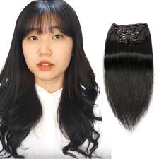 She's got long, straight, black hair. 18 Inch Straight Clip In Hair Extensions Black 1
