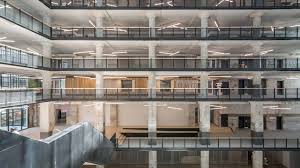 Open floor plan features high ceilings and a large kitchen with tile counter tops. Archimania Transforms Memphis Warehouse Into Teacher Training Centre