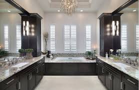 Luxurious bathroom boasts a dark stained dual washstand topped with gray and white quartz countertops, which resemble marble, fitted with his and her sinks and polished nickel gooseneck faucets tucke dudner inset framed medicine cabinets lining a shiplap wall lit by hudson valley lighting aberdeen sconces. Bathroom Remodel With Dark Cabinets 96319 Design Ideas Pictures