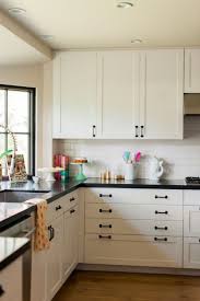 Shaker style kitchen with white cabinetry and black appliances. White Kitchen Cabinets With Black Hardware Morespoons Where To Place Layjao