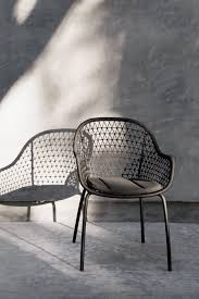 A Modern Beauty The Sylva Rests On A Slim Curved Aluminum Frame And Features A Knotted Pattern Of Weatherp Outdoor Dining Chairs Dining Chairs Deck Furniture