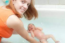 Mother Bathes Newborn Baby In Bath Focus On Woman Stock Photo Picture And Royalty Free Image Image 15978281