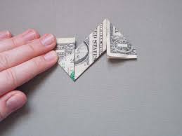 This is a classic 5 pointed origami star that you've probably been drawing your your origami should now look like this. Make A Dollar Bill Origami Ninja Star
